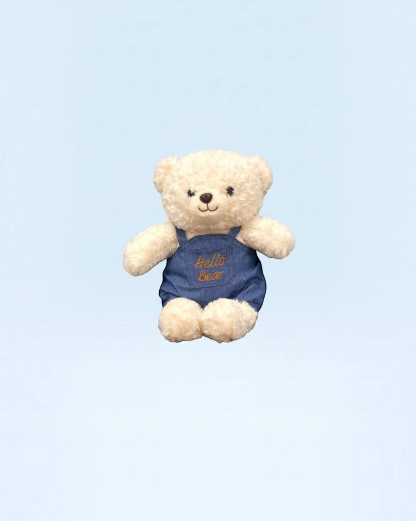 دب محشو ناعم من TagerlSaada بفرو كريمي ووزرة جينز زرقاء مطرزة بعبارة Hello Bear للعب والعناق